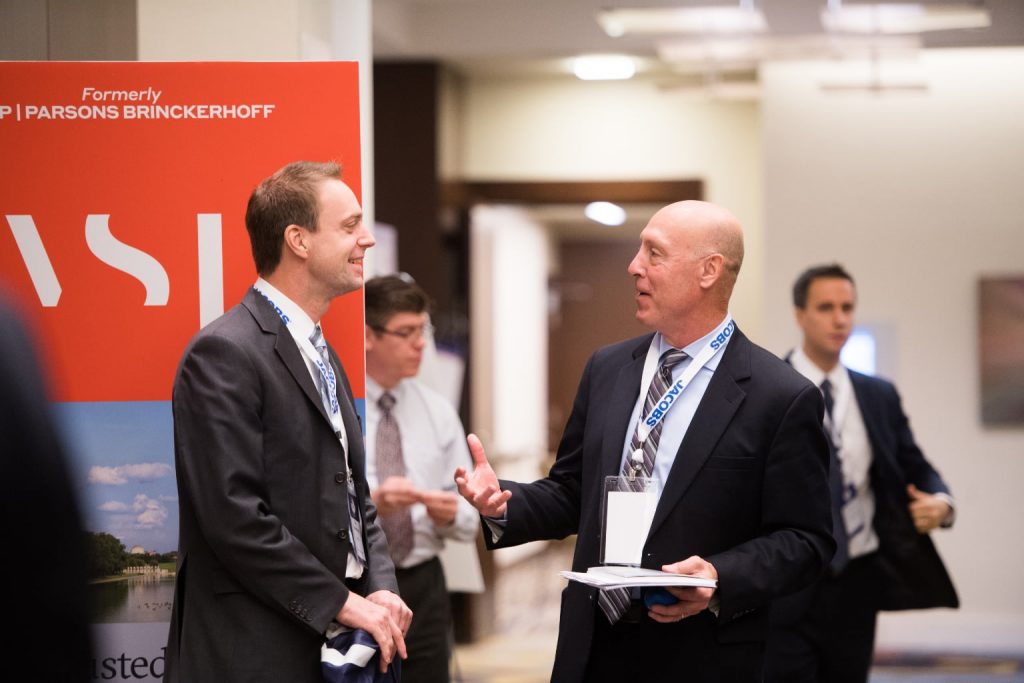 colleagues networking at a booth
