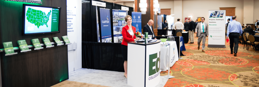 woman standing at exhibit booth