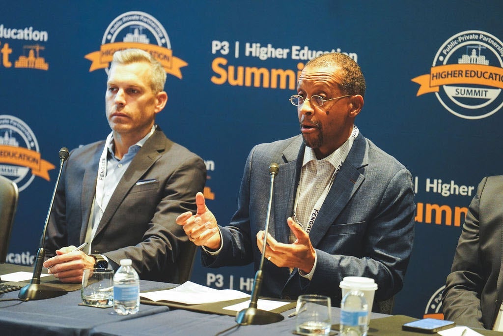 Panelists speaking at the P3 Higher Education Summit